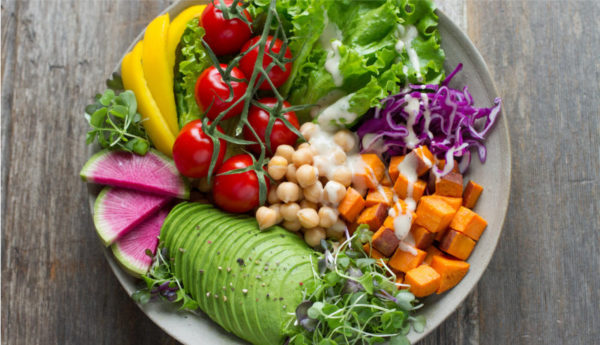 plate full of vegan foods, salad, chickpeas, butternuts squash, avocado